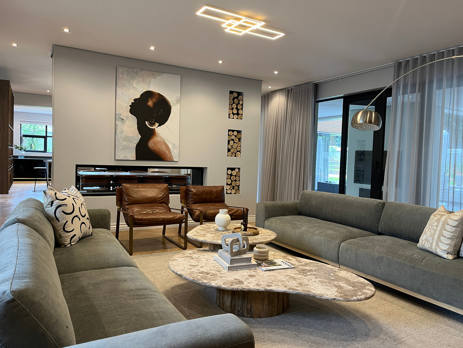 Sitting room with arc floor lamp, chaise sofa and houndstooth chairs
