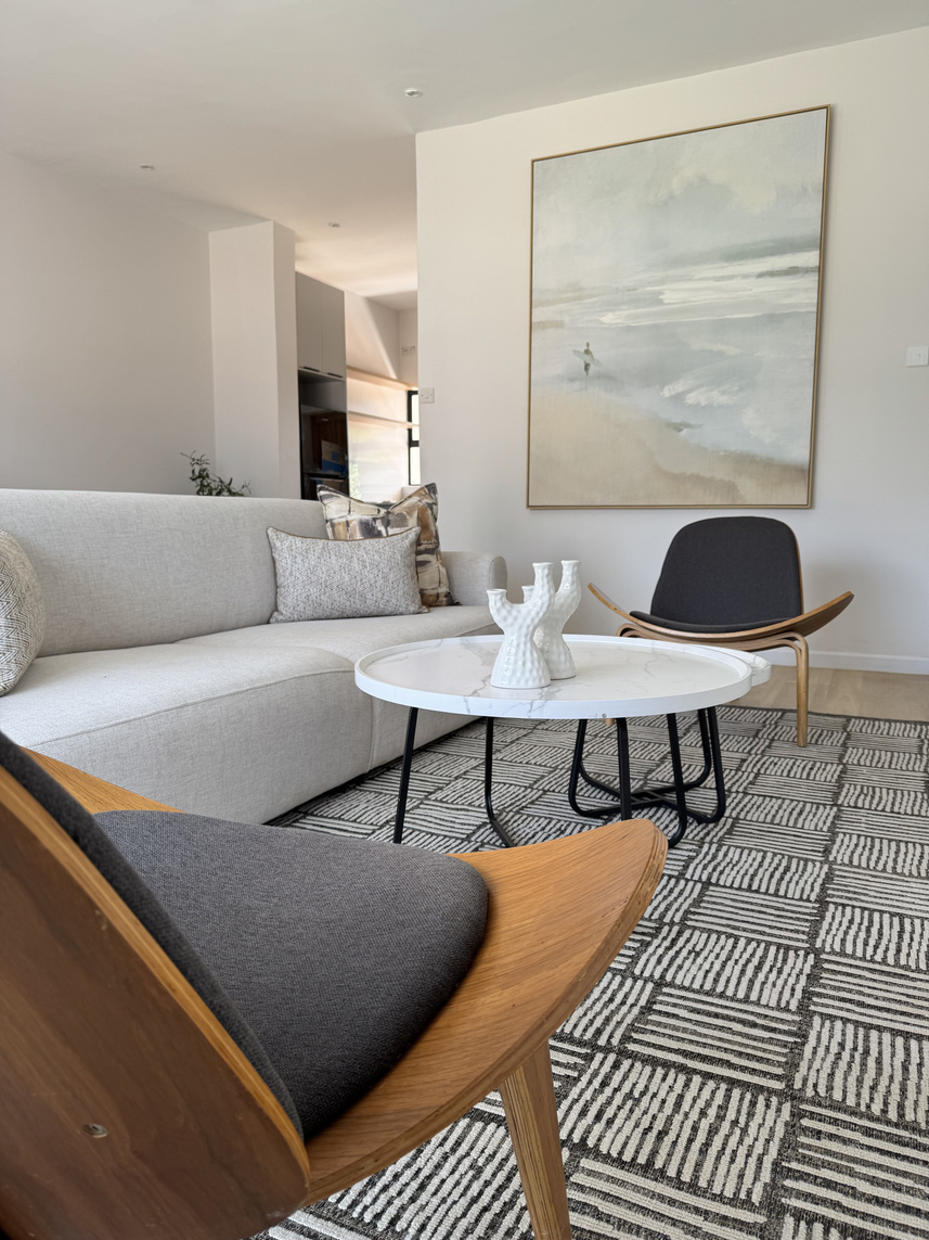 Apartment living room with sectional and tan chair
